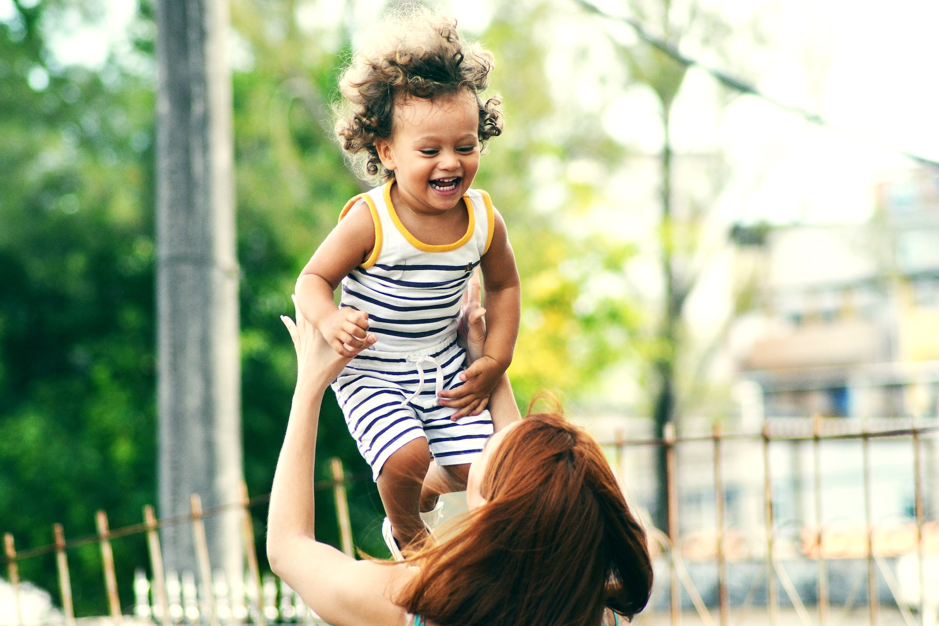 A young girl is supported by an adult