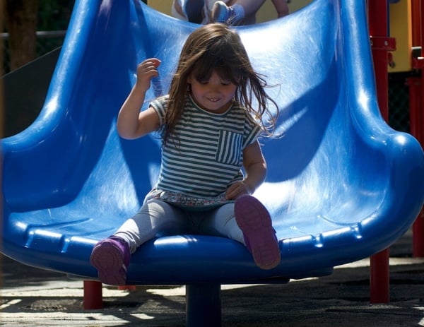 Girl going down slide