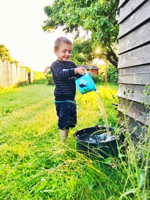 young boy doing waterplay